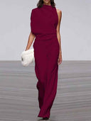 Maroon sleeveless jumpsuit with draped neckline, front view on a runway.