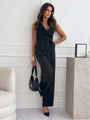 Black sleeveless jumpsuit with V-neck, waist tie, and wide legs, full front view.