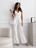White sleeveless jumpsuit with V-neck, wrap waist tie, and wide legs, full body view.
