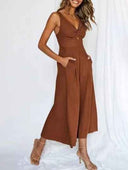 Brown wide-leg overall with V-neck, front knot detail, and pockets, angled view on white background.