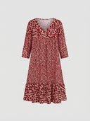 Red mini dress with white floral print, V-neck, and tiered skirt, front view.