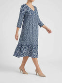 Blue floral mini dress with ruffled hem, side angled view on a white background.
