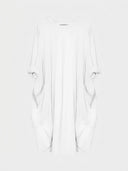 White mini shirt dress with rolled sleeves and two front pockets, front view.