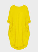 Yellow mini shirt dress with rolled sleeves and two front pockets, front view on white background.