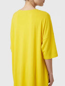 Yellow mini shirt dress with short sleeves, shown from the back on a white background.