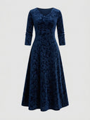 Navy blue velvet maxi dress with floral pattern, V-neck, and long sleeves, front view.
