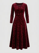 Red velvet maxi dress with V-neck and long sleeves, floral pattern, front view on white background.