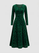 Emerald green velvet maxi dress with floral pattern, V-neck, and long sleeves, front view.