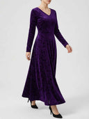 Purple velvet maxi dress with long sleeves and V-neck, angled view on a white background.