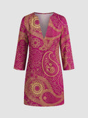 Magenta mini dress with gold paisley pattern and V-neck, front view on a white background.