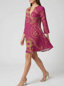 Magenta mini dress with gold paisley pattern, angled side view on a white background.