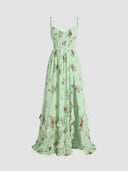 Light green floral maxi dress with corset bodice, thigh slit, and ruffled hem, front view.