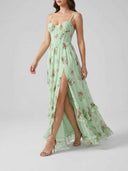 Mint green floral maxi dress with high slit, ruffled hem, and corset bodice, angled view.