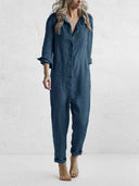 Woman in blue utility jumpsuit with rolled sleeves, chest pockets, and side pockets, full front view.