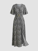 Gray and white patterned maxi dress with V-neck, short sleeves, gold buckle belt, and side slit, front view.