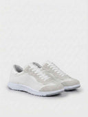 White lace-up low-top sneakers with ridged flexible sole and mesh upper, angled overhead view on white background.