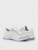 White trainers with suede heel counter, mesh upper, and white laces — angled rear-quarter view on white background.
