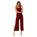 Red flared leg jumpsuit with adjustable straps, front view on white background.