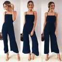 Navy blue flared-leg jumpsuit with adjustable straps, shown from multiple angles.