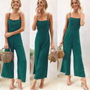 Emerald green jumpsuit with adjustable spaghetti straps and flared legs, full-length view.