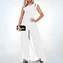 White wide-leg jumpsuit with shoulder cutouts, holding a black clutch, front view.