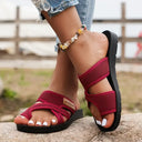 Burgundy cushioned open-toe sandals with wide mesh strap and black non-slip sole, angled side view worn on foot.