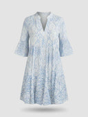 Viola boho mini dress in blue paisley print, front view showing split notch collar and fluted bell sleeves on white background.