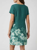 Viola green floral border print short sleeve mini shift dress, back view showing clean straight shift silhouette.