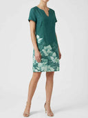 Viola teal floral border print short sleeve mini shift dress with split V-neckline, front three-quarter view on model.