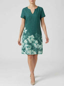 Viola teal short sleeve mini shift dress with white border floral print on lower skirt, front view on white background.
