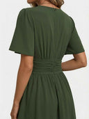 Olive green mini dress with ruched waist and back zipper, back view.