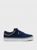 Navy blue low-top canvas sneakers with white sole, gold chain detail and white lace-up closure, side view on white background.