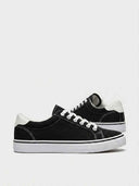 Black canvas lace-up trainers with white sole and heel counter tab, side view on white background.