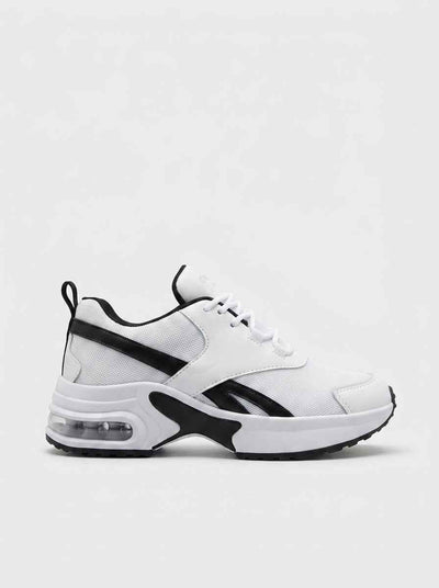 Chunky white lace-up trainers with visible air-cushion midsole and black contrast panels, side profile on white background.