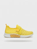 Yellow slip-on knit trainer with sparkle upper, wide elastic strap, and white sole — side view on white background.