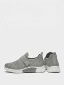 Grey sparkle-knit slip-on trainer with white sole and elasticated strap — angled product shot on white background.