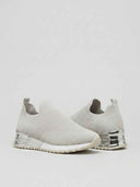 Grey slip-on knit trainers with white non-slip soles and silver chrome heel accents, pair angled view.