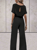 Black short sleeve jumpsuit with keyhole back, shown from the back on a light background.
