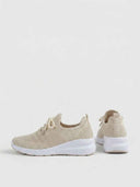Pair of beige knit arch-support trainers showing side and rear views of the white cupsole and lace-up upper.