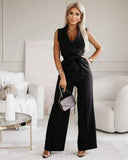 Black V-neck jumpsuit with integrated tassel tie belt, full-body front view on a neutral background.