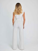 White sleeveless jumpsuit with a cinched waist, back view on a white background.
