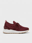 Red mesh trainers with knit upper, white midsole, and tan gum rubber outsole, side view on white background.