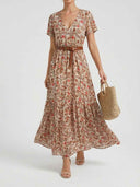 Cream floral mini dress with short sleeves, V-neck, and brown belt, front view on white background.