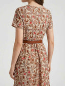 Beige floral mini dress with short sleeves and brown belt, back view.
