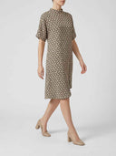 Beige patterned knee-length dress with short sleeves and mock neck, angled side view.