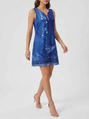 Blue floral sleeveless midi dress with white buttons, worn by a model, angled front view.