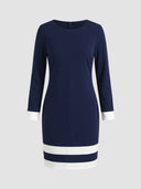Navy blue mini dress with white cuffs and two white stripes on the hem, front view.