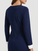 Navy blue mini dress with white cuffs, back view, zipper detail.