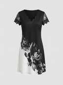 Black and white midi dress with scalloped V-neck, lace sleeves, and floral print, front view.