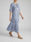 Blue and white ikat print maxi dress with tassel tie, side angled view.